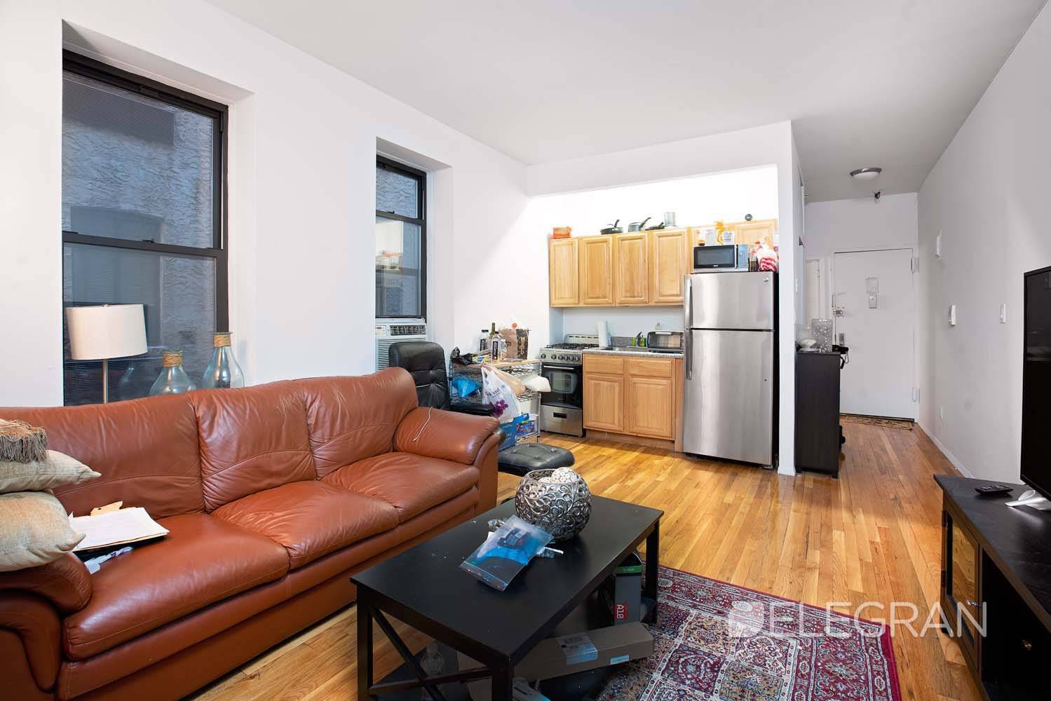 True 2 bedroom with elevator featuring a spacious, rectangular living space and an open kitchen.