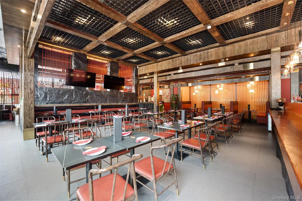 Dining room with a towering ceiling, coffered ceiling, and beam ceiling