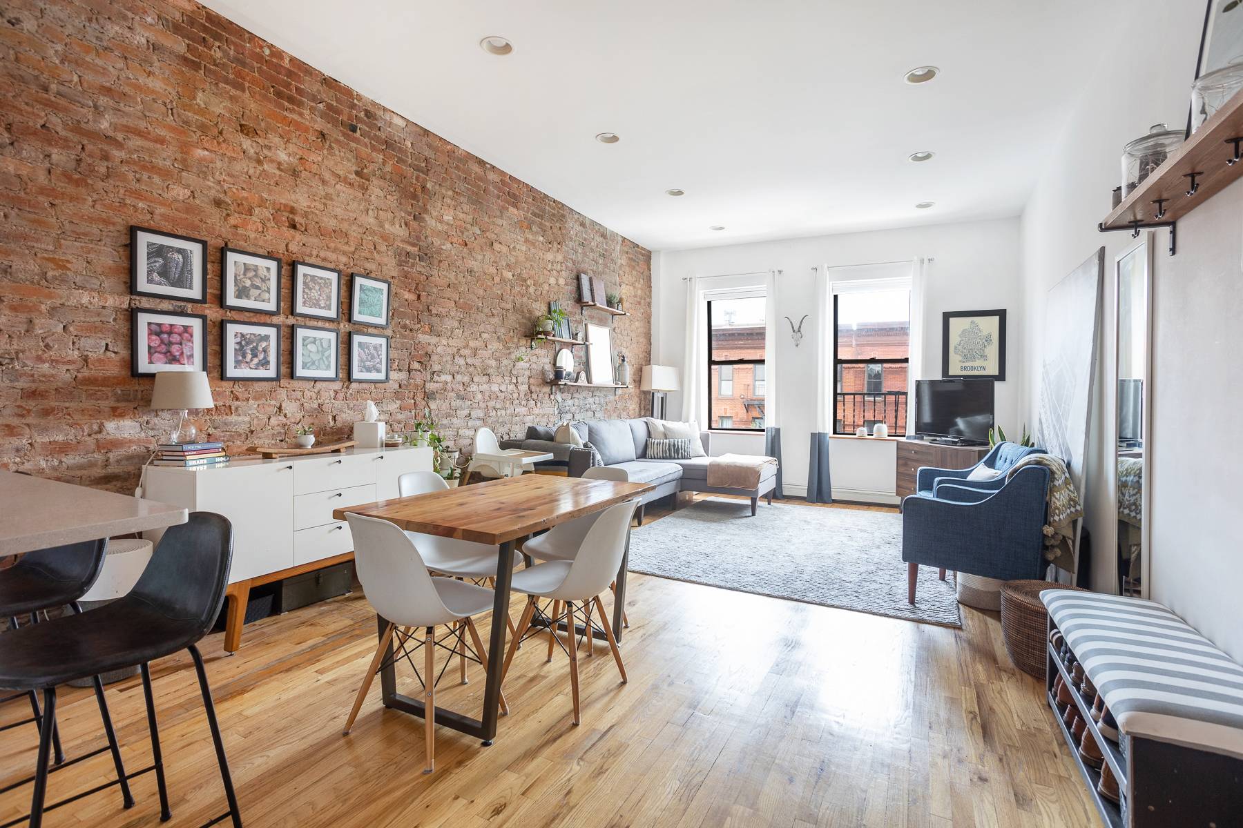 The moment you open the front door you ll be drawn into a sunny, open concept living room accented by beautiful exposed brick, a 10 foot high ceiling, and a ...