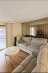Living area with plenty of natural light, wood finished floors, a textured ceiling, and radiator heating unit