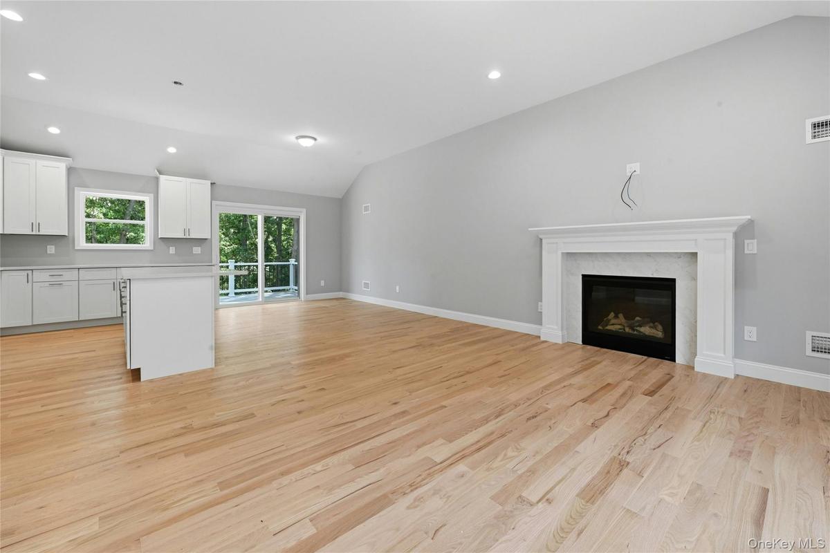The open-concept layout seamlessly connects the living room, dining area and kitchen, creating an ideal space for everyday living and entertaining.