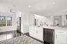 Kitchen featuring a sink, ceiling fan, dark wood-style floors, white cabinetry, and stainless steel appliances
