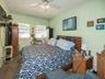 Bedroom featuring ornamental molding, ceiling fan, and carpet