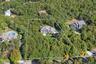 View of property location with a heavily wooded area and property boundaries highlighted