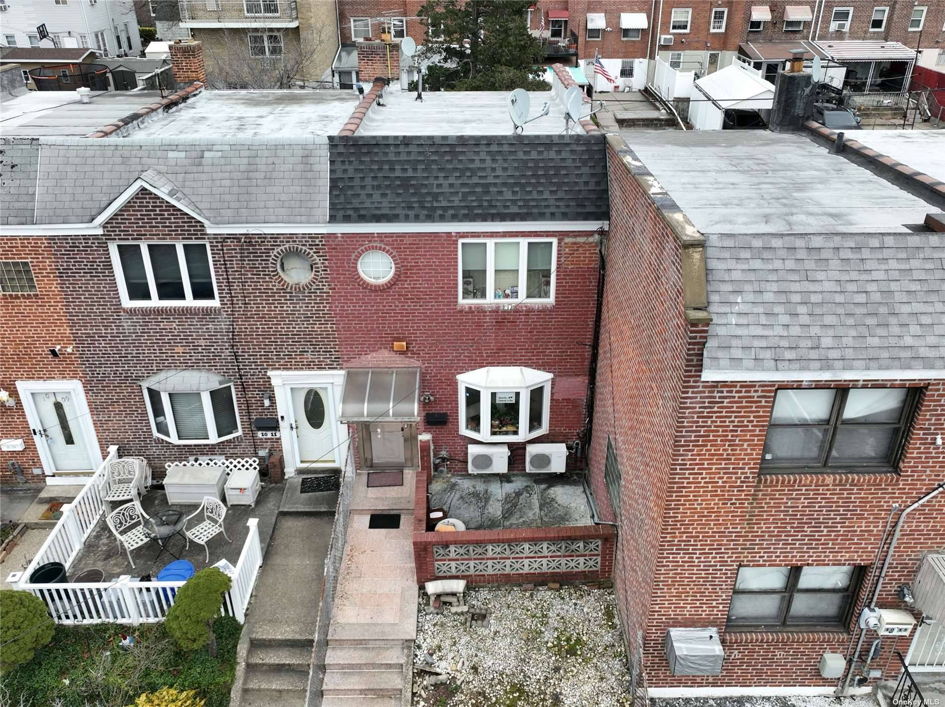 A very good condition solid brick townhouse in College Point ; It features one large living room, one kitchen, and a dining room on the first floor.