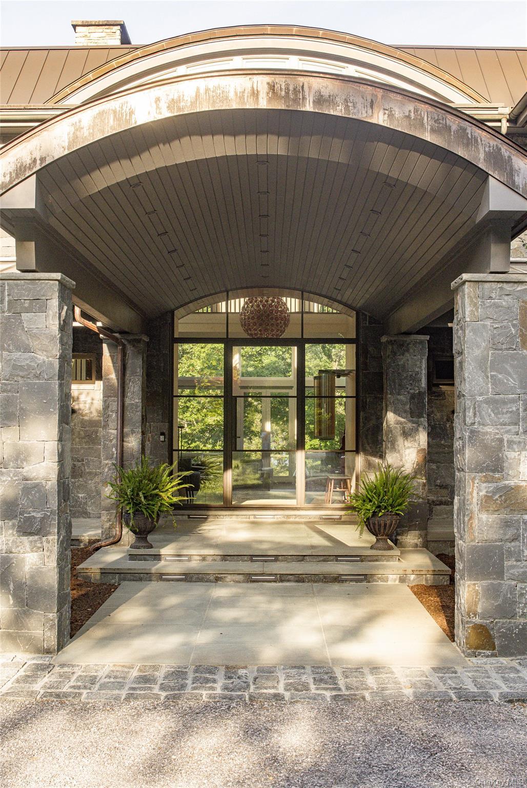 Doorway to property featuring french doors and stone siding