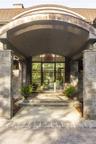 Doorway to property featuring french doors and stone siding