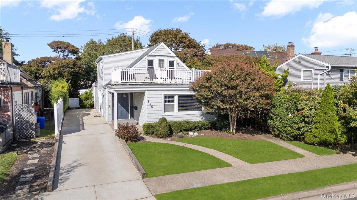 View of front of house with a front lawn and driveway