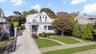 View of front of house with a front lawn and driveway