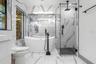 Primary Bathroom, Marble Flooring, Separate Vanities, Stand Alone Tub, Seamless Glass Enclosed Shower w/ Rain Shower Fixture.