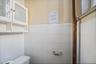 Half bath with toilet and tile walls