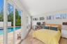 Bedroom with sliding glass doors to pool area.