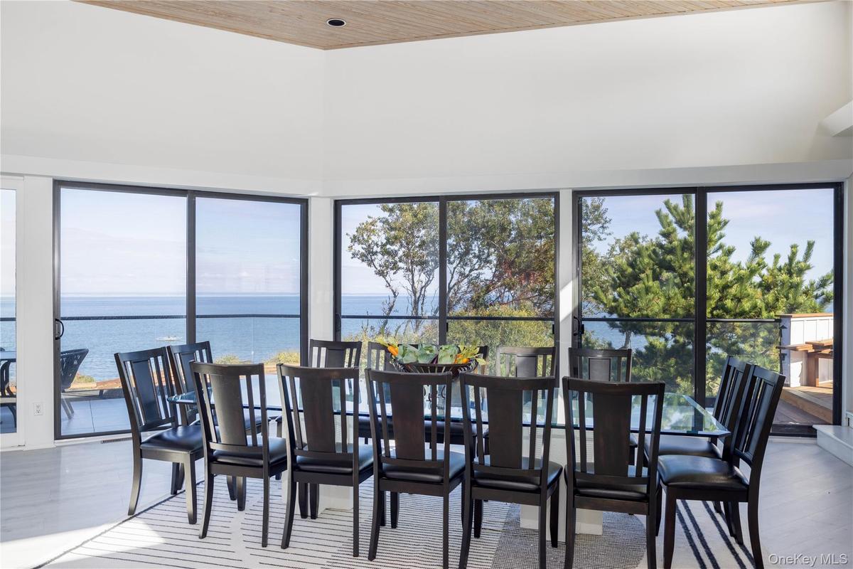 Dining space with a water view, plenty of natural light, and wood finished floors