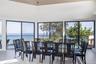 Dining space with a water view, plenty of natural light, and wood finished floors
