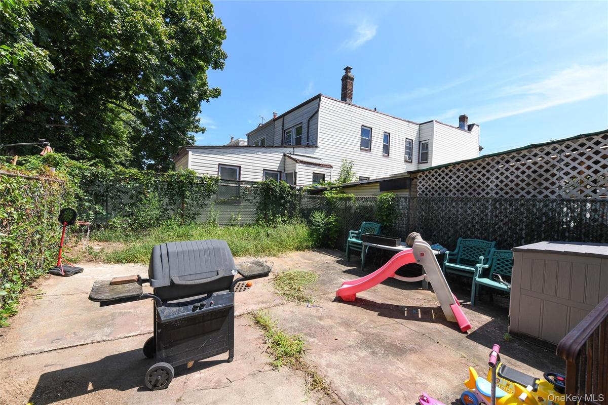 Fenced backyard with a grill and a patio area