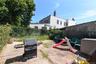 Fenced backyard with a grill and a patio area