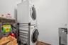 Laundry room featuring estacked washer and dryer and wood finished floors