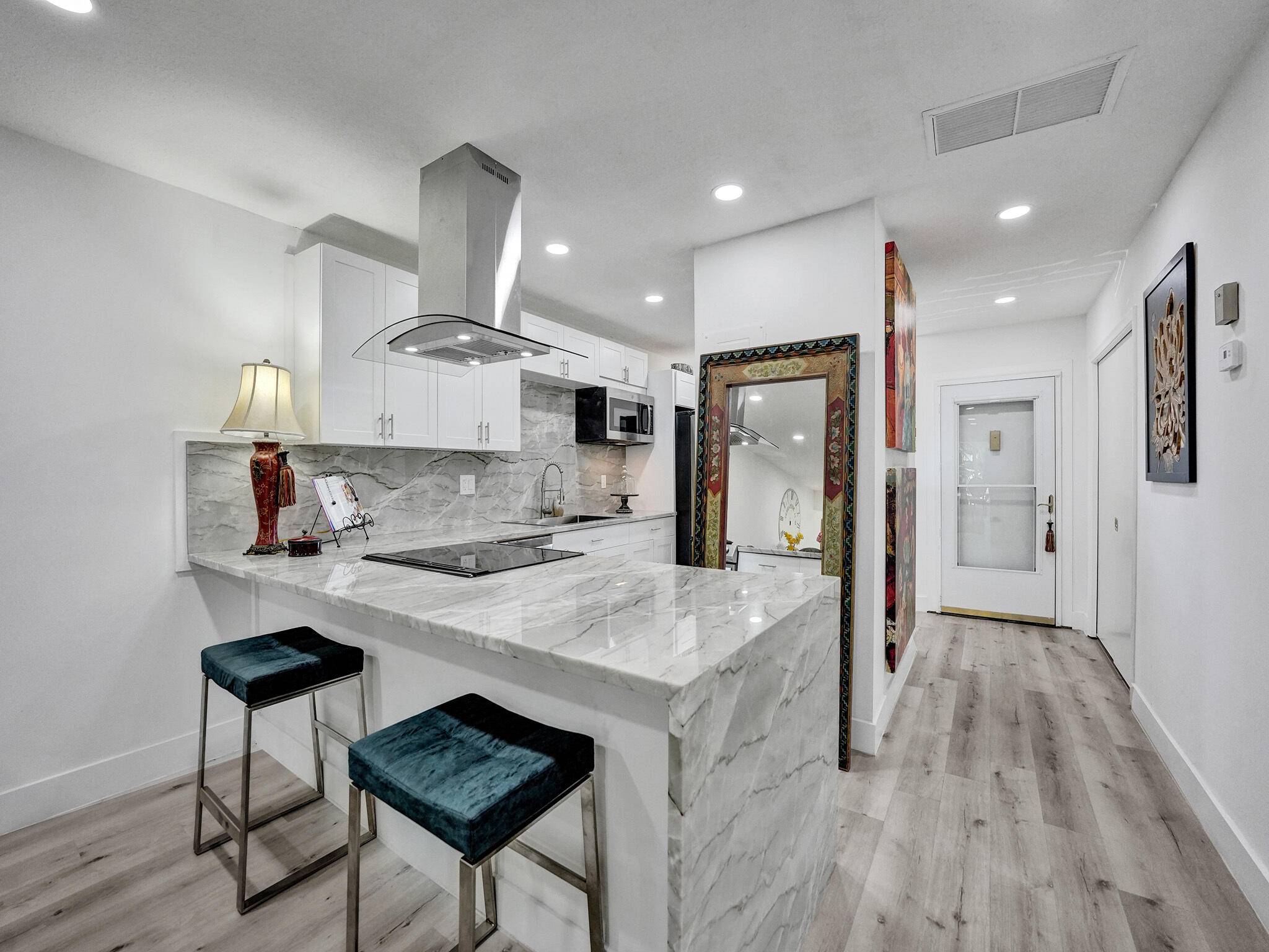PINES OF DELRAY WEST. Step into this beautifully renovated property featuring an open kitchen with Cambridge white Woodcrafters cabinetry ; quartzite counter tops, quartzite backsplash and quartzite top coffee bar ...