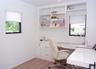 Office space featuring light wood-style floors and built in study area