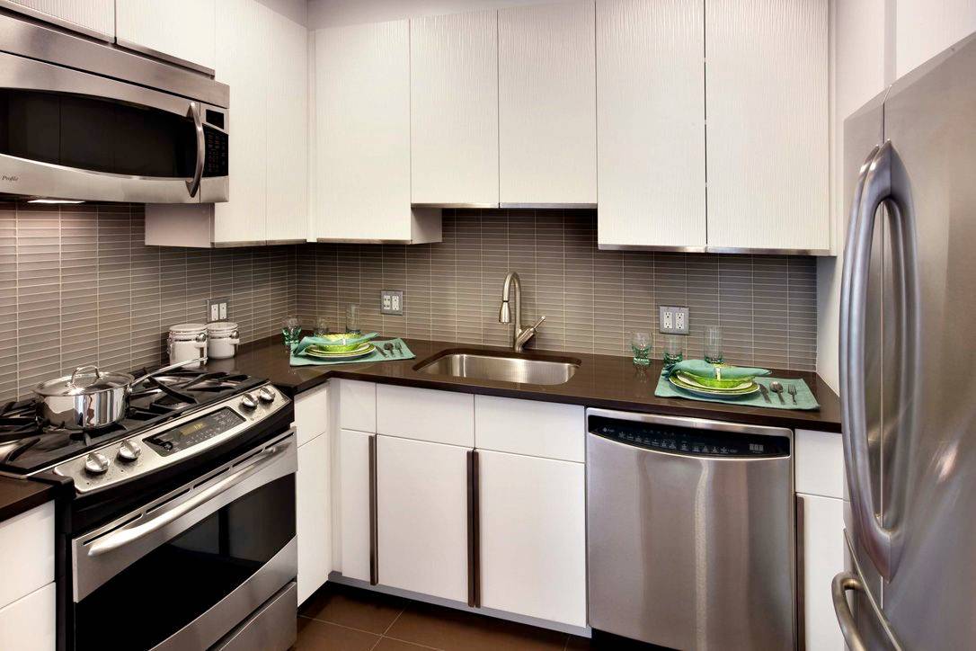 Great 1 bedroom featuring a large u shaped gourmet kitchen with quartz counters and stainless steel appliances and floor to ceiling windows showcasing west NYC skyline views.