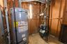 Utility room featuring gas water heater