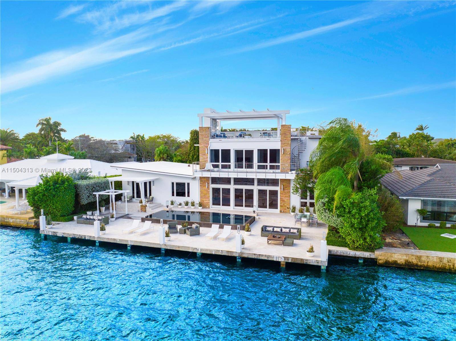 CONTEMPORARY MID CENTURY INSPIRED WATERFRONT ESTATE WITH UNOBSTRUCTED VIEWS !