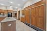 Wood cabinetry adorning the oversized Refrigerator/Freezer