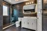 Contemporary bathroom featuring slate-toned tiled walls and flooring