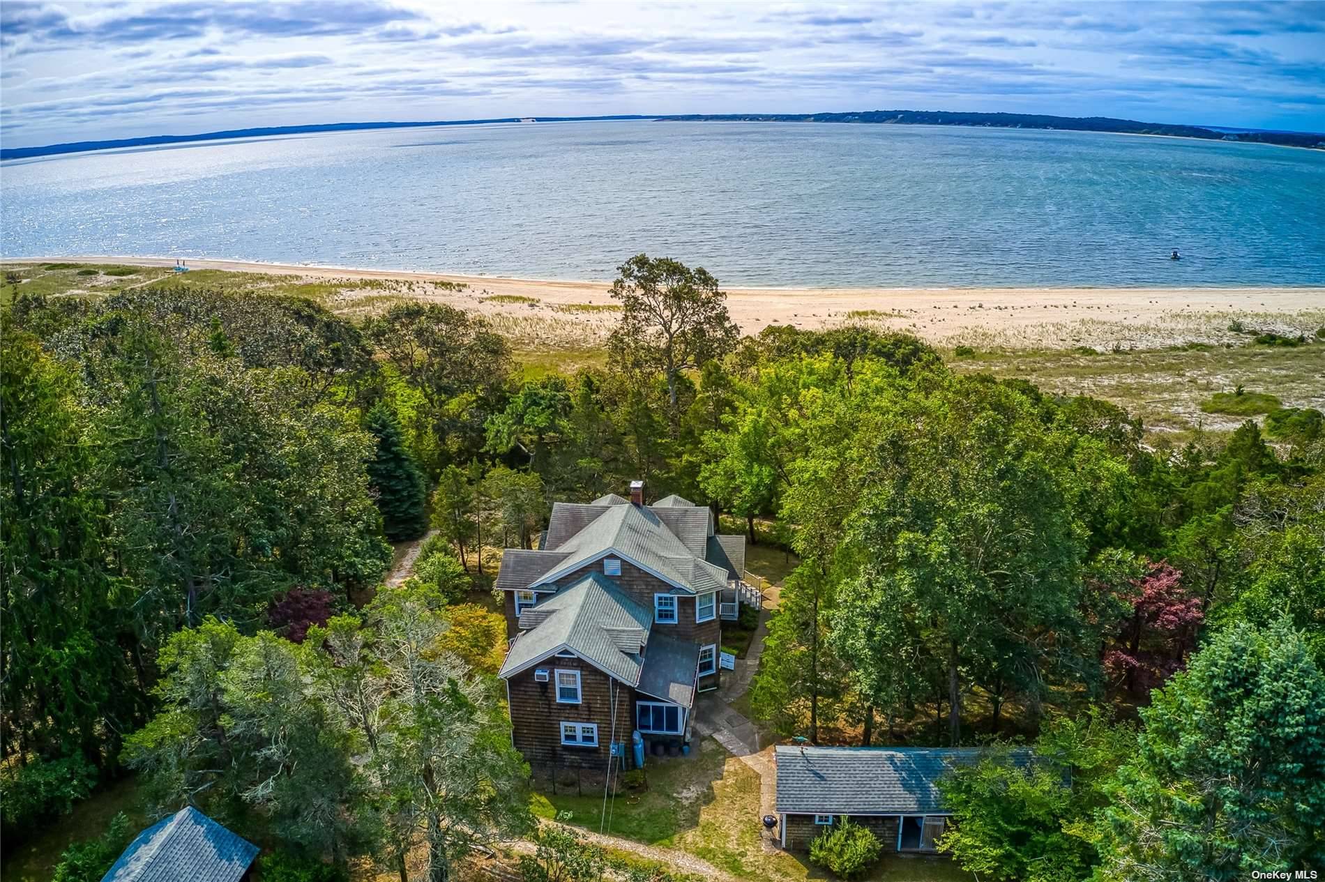 Southold, North Fork This beautiful estate, bayfront home offers complete privacy in a peaceful woodland setting with a historic provenance and featuring a sugar sand beach.