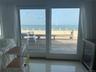 Doorway featuring a water view, wine cooler, and tile patterned flooring
