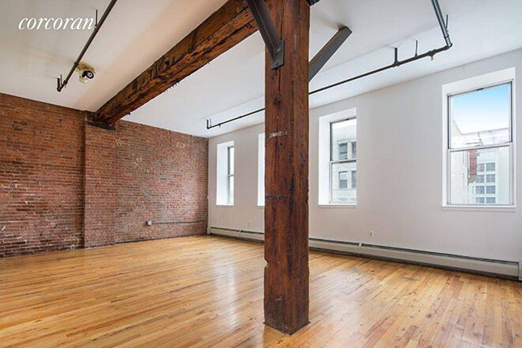 Residence 5D is a spacious and sunny, top floor factory loft with original wood beams, brick and iron work.