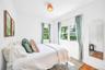 Bedroom with wood finished floors and baseboards