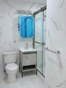 Full bathroom featuring vanity, a marble finish shower, and marble finish floors