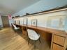 Office space featuring light wood finished floors and built in desk