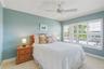 The large guest room has lots of Florida sun and comes with gorgeous plantation shutters and a custom closet system!