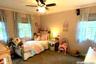 Carpeted bedroom featuring a ceiling fan and crown molding