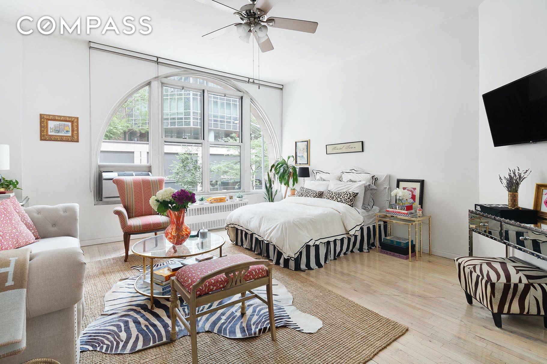 Rare pre war studio loft with 10 foot ceilings and a dreamy double wide arched window flooding the home with natural light.