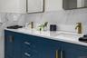 Rich navy cabinetry paired with quartz counters and gold hardware creates a sophisticated yet serene space perfect for daily routines or a spa-like un