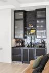 Wet bar includes 24" Thermador refrigerator and 24" Fisher & Paykel single door dishwasher