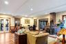 Living area featuring french doors, beamed ceiling, a wood stove, healthy amount of natural light, and recessed lighting
