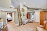 Vaulted ceilings with recessed lighting over wood-finish flooring