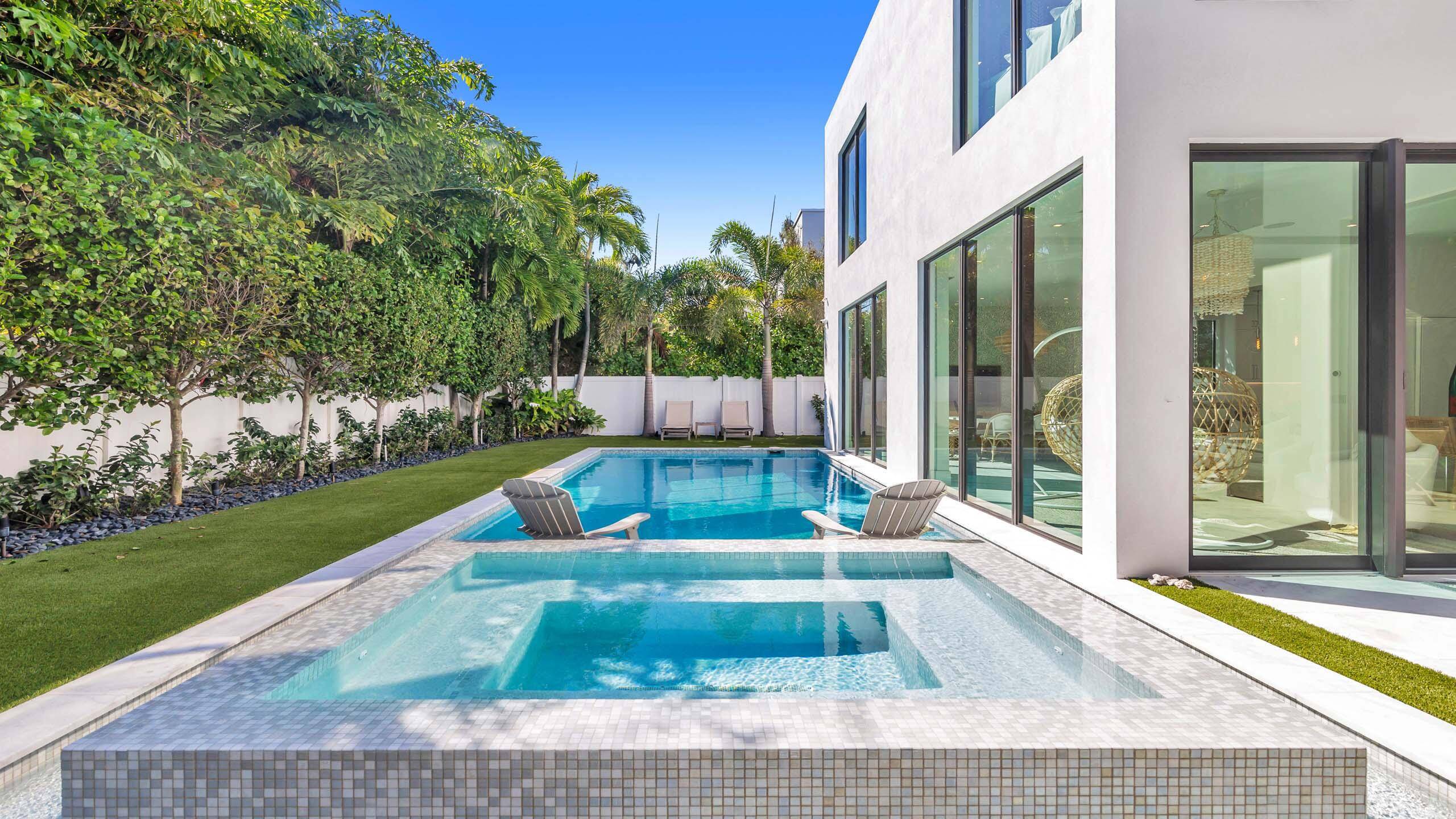 Built in 2021, this incredible contemporary residence is located in Boca Villas just one block from the famed Mizner Park and one mile to the beach.