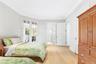 Bedroom with ornamental molding, light wood finished floors, access to outside, and connected bathroom