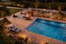 Resort-style pool and spa illuminated for unforgettable evenings under the stars.