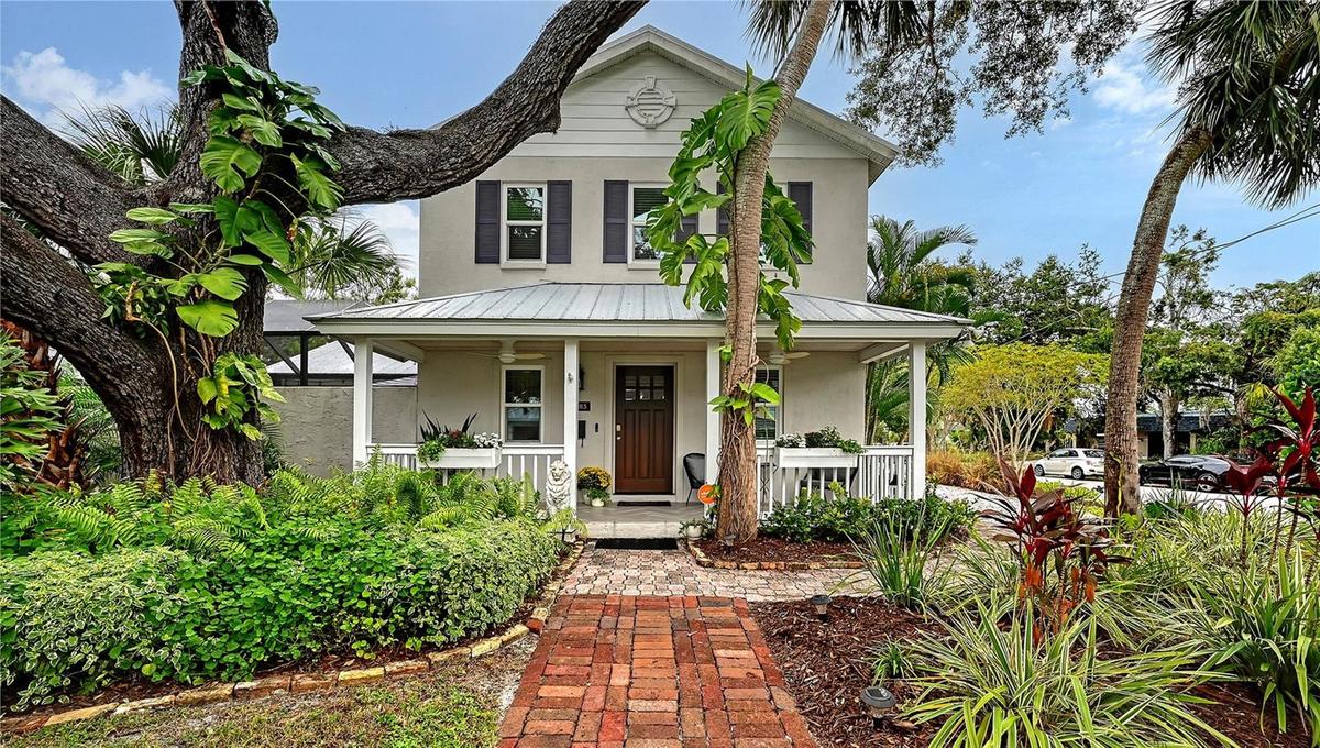 Beautifully landscaped Key West–inspired residence welcomes you with timeless architectural character, mature tropical landscaping, and an impressive