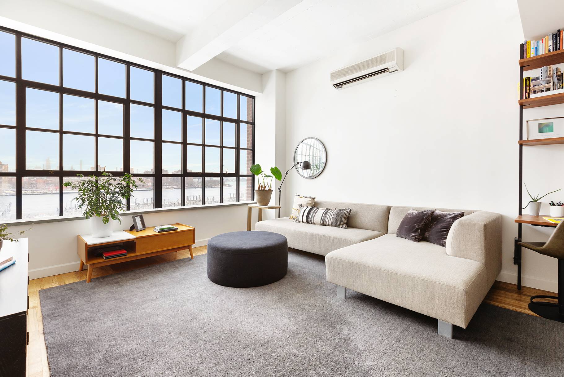 Upon entering the home, you'll be immediately drawn to the wall of industrial style windows facing the East River.
