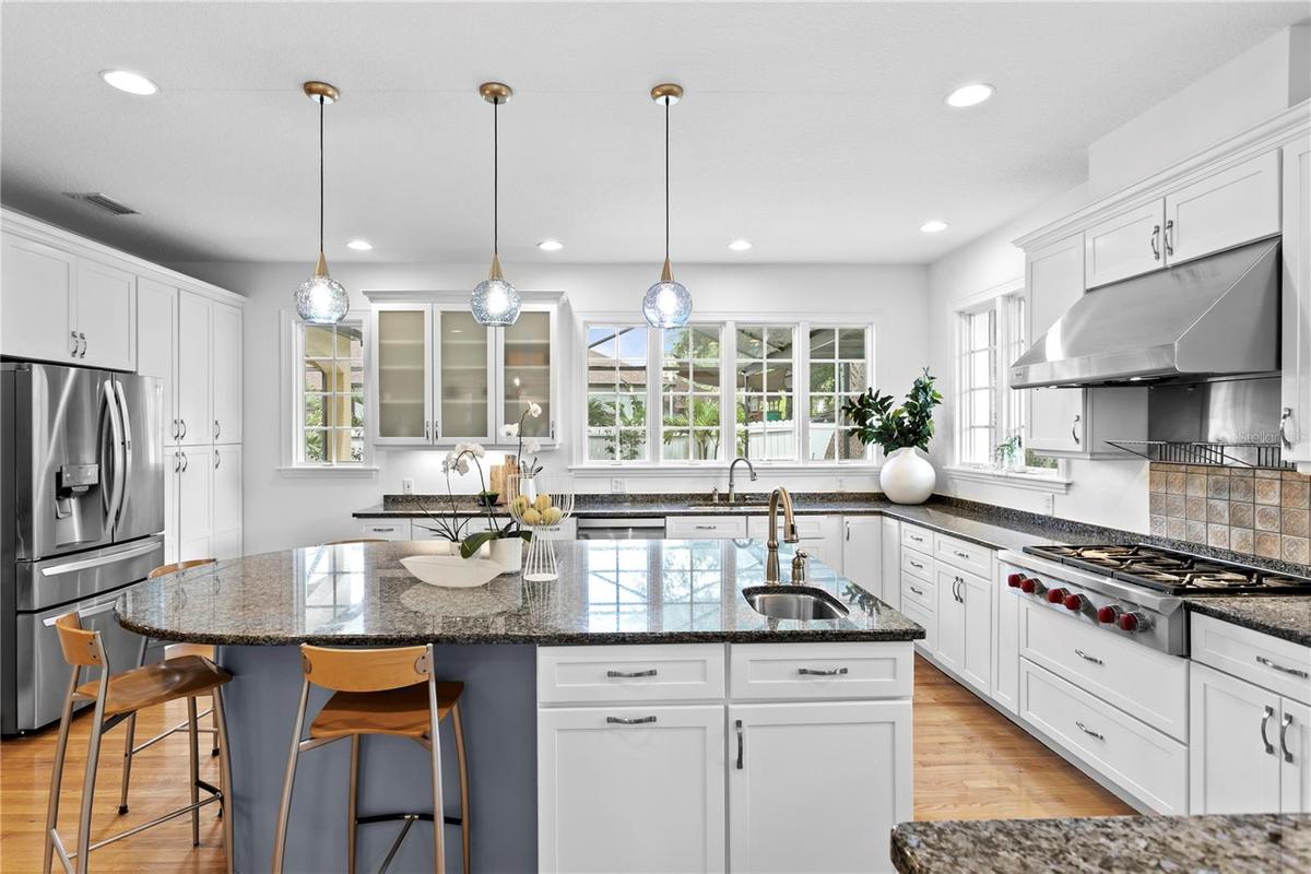 An epicurean masterpiece featuring pro-series appliances & an expansive commanding island
