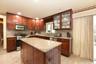 Kitchen with sink, backsplash, stainless steel appliances, and a center island
