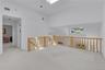 Loft with a skylight and an abundance of natural lighting flowing through the second level.