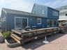 Back of house featuring a wooden deck and board and batten siding